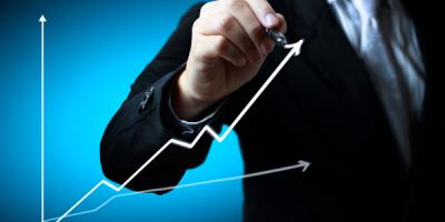 Business man hand drawing a graph